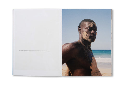 Open photography book "Hola Mi Amol" by SPBH Editions with black-and-white images displayed on pages.