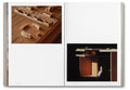 Open art book titled "Donald Judd Spaces" by Judd Foundation showcasing photographs of Judd's minimalist architectural works.