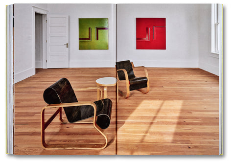 Open art book titled "Donald Judd Spaces" by Judd Foundation, showcasing images of minimalist architectural designs and interior spaces.