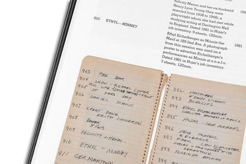 Close-up of a photography book titled "Hujar: Contact" by MACK, showing detailed pages of black-and-white photographic contact sheets.